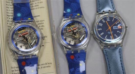 Three assorted Swiss Swatch wrist watches.